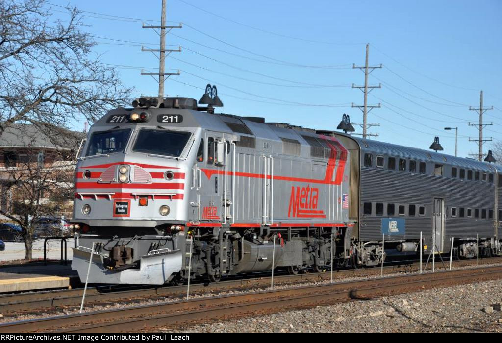 Westbound commuter comes into the station behind the Burlington heritage unit